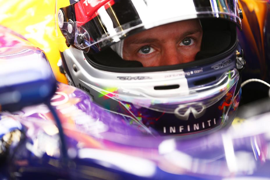 Racecar driver looking up with his helmet on