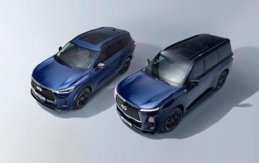 Top-angled view of two blue SUVs displayed side by side in a studio setting