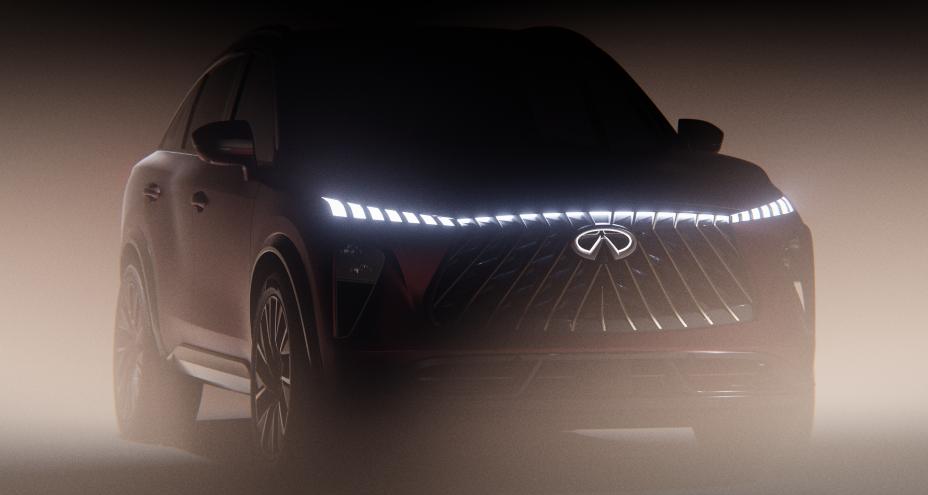 Front angled view of the QX65 Monograph, the headlights are illuminated, a haze of light is in front of the vehicle.