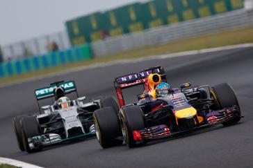 Two F1 racecars right behind each other