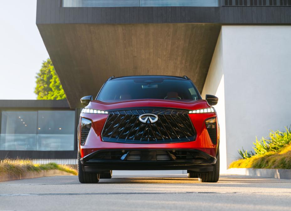 Front view of the 2027 INFINITI QX65 parked in front of a modern building.