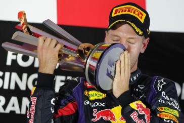 Infiniti Red Bull driver kissing the trophy.