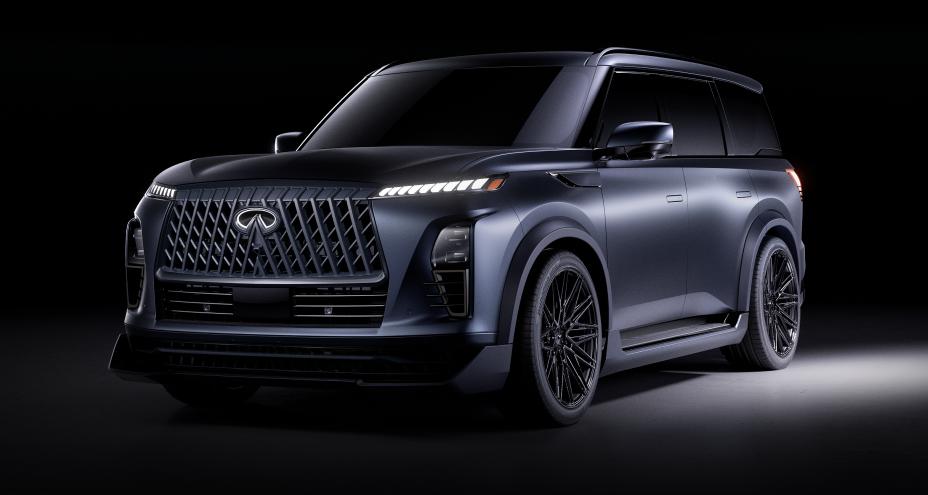 Front left 3/4 view of the INFINITI QX80 Track Spec, a spotlight illuminates the vehicle from the side.