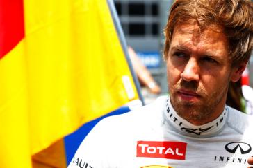 Racecar driver looking into the sun very seriously