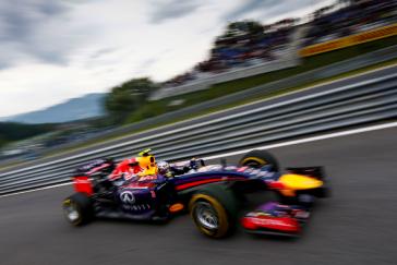 Blurred image of INFINITI racer speeding by going left to right