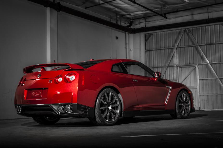 Rear angled view of the 2015 Nissan GT-R in Regal Red parked in a garage.
