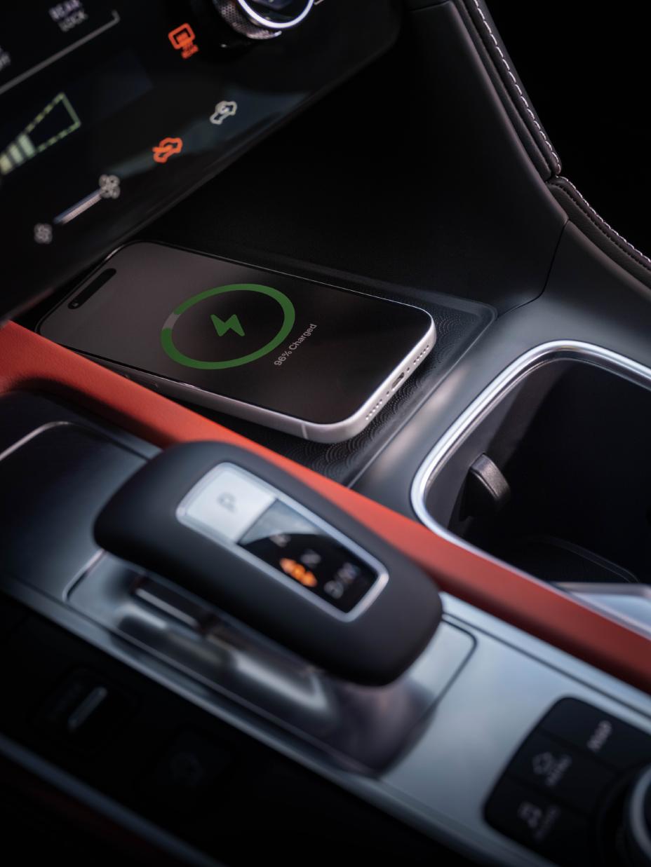 Close up of the gear shift and mobile device charger area inside the 2027 INFINITI QX65.