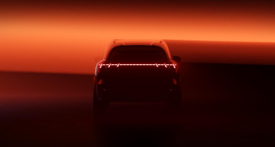 Rearview of the QX65 Monograph, a beam of amber light shines over the vehicle.