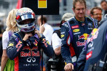 Driver unbuckling his helmet