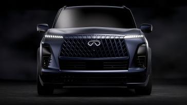 Front view of the INFINITI QX80 Track Spec, the headlights and emblem of illuminated.