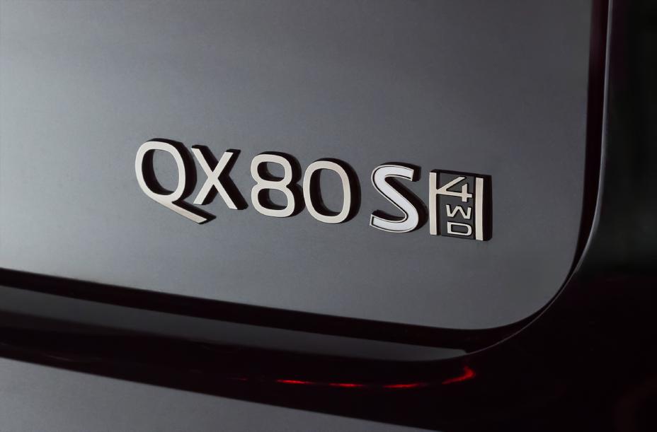 Close-up of the rear badge on a 2026 INFINITI QX80 Sport 4WD, showing the model designation in chrome lettering against the black vehicle surface.