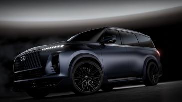Lower angled view of the INFINITI QX80 Track Spec, a beam of light shows overhead.