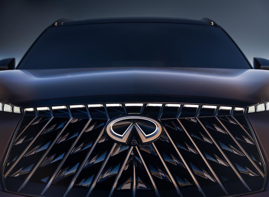 Close up front view of the grill on the QX65 Monograph, the headlights and emblem of illuminated.