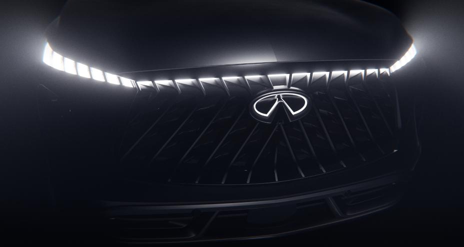Close up of the grill and headlights on the QX65 Monograph, the headlights and INFINITI emblem shine brightly.