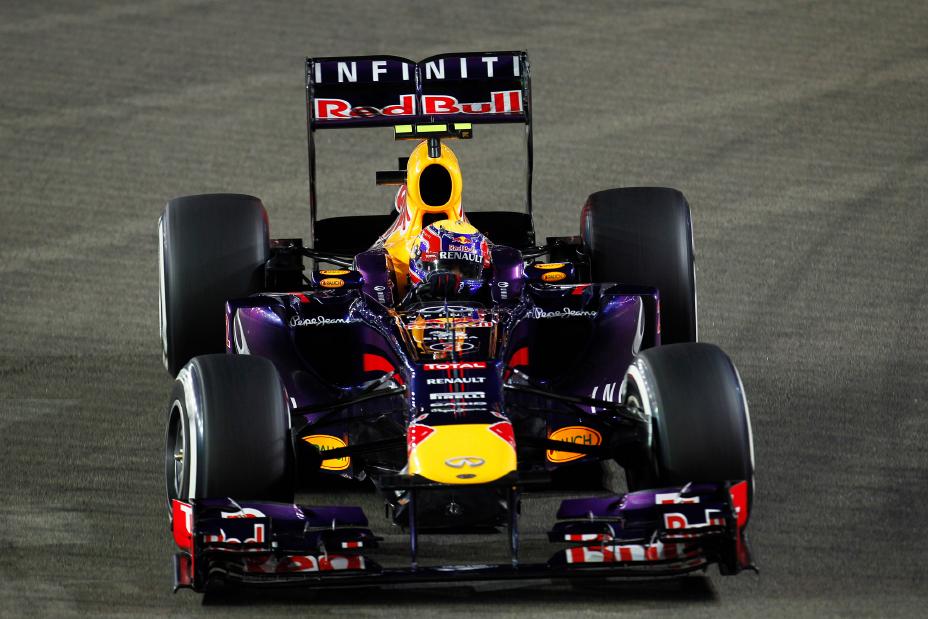 Front view of F1 team with the driver inside his car.